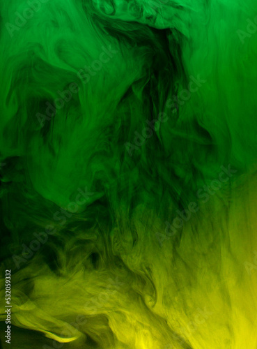swirling clouds of green and yellow smoke randomly mix on a black background