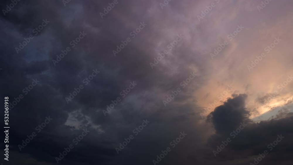 Beautiful sun rays appearing behind grey clouds at sunset. Cloudscape timelapse. Beautiful sun rays appearing behind grey clouds at sunset. Cloudscape timelapse.