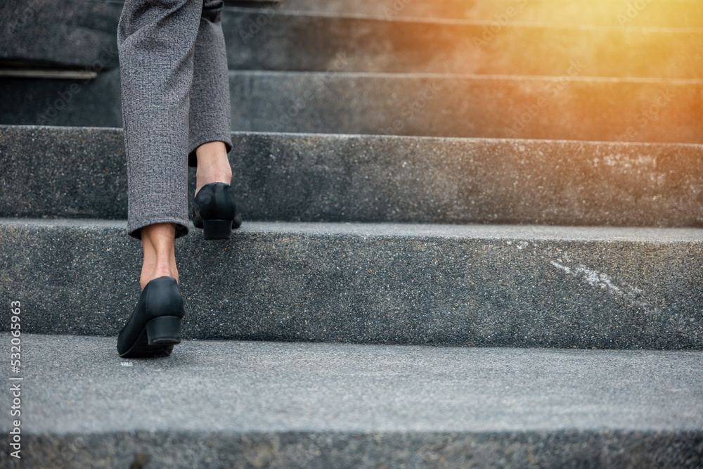 Stepping going up stairs in city, Closeup legs of businesswoman hurry up walking on stairway, rush hour to work in office a hurry in morning, foot of business woman wear black shoes step up success Stepping going up stairs in city, Closeup legs of businesswoman hurry up walking on stairway, rush hour to work in office a hurry in morning, foot of business woman wear black shoes step up success