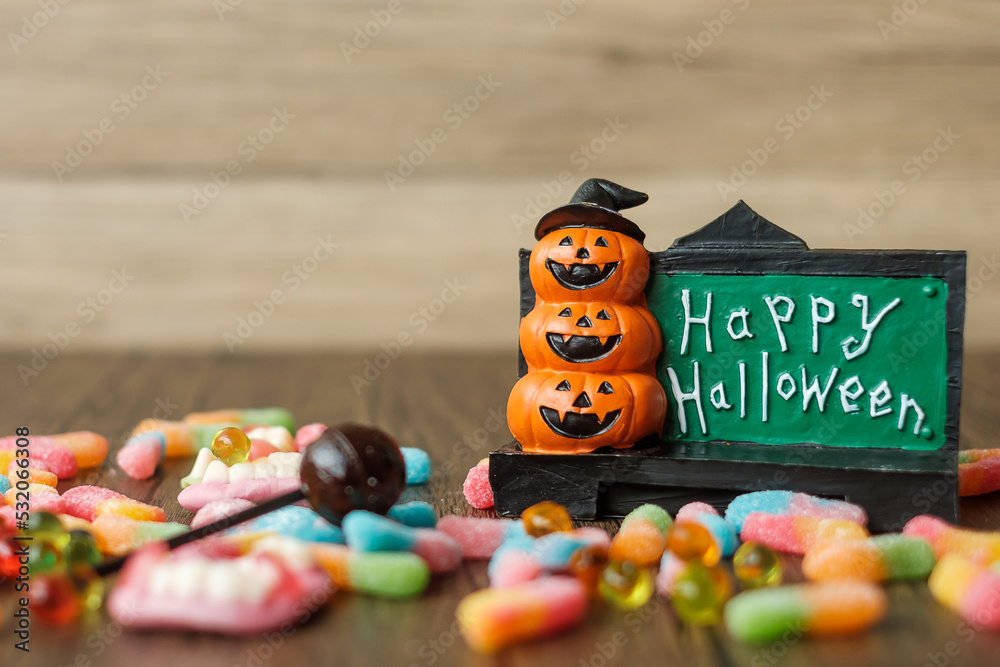 Fototapeta premium Happy Halloween day with ghost candies, pumpkin bowl, Jack O lantern and decorative (selective focus). Trick or Threat, Hello October, fall autumn, Festive, party and holiday concept