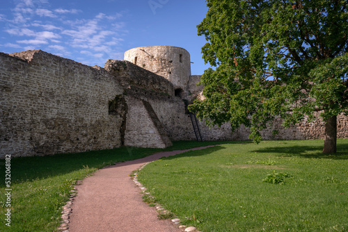 View of the Izborsk Fortress wall and the Temnushka Tower, on a sunny summer day, Izborsk, Pskov region, Russia photo