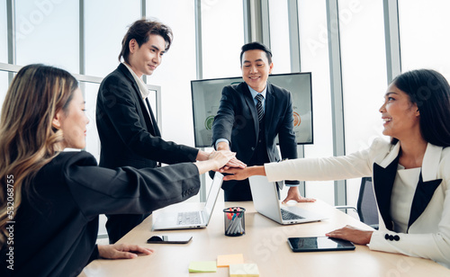 Stack of hands symbolizing trust and cooperation, Group of professional business people are working and brainstorming discussed about work in conference room.