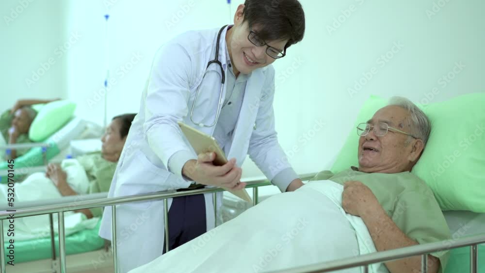 Doctor giving elder man talking to his family via video conference on tablet. Doctor giving elder man talking to his family via video conference on tablet.