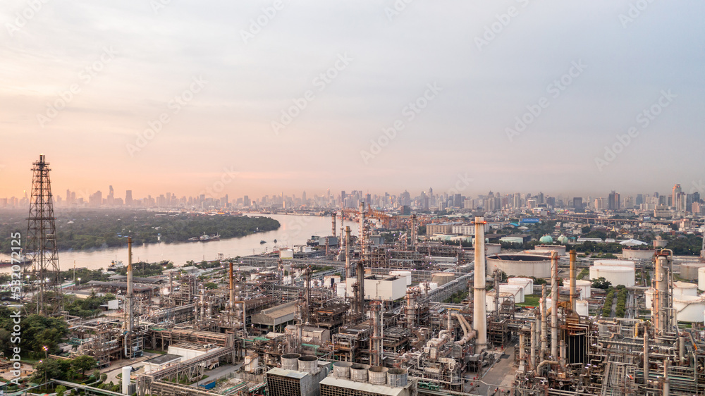 Aerial view oil and gas industry refinery at sunset, Aerial view oil and gas Industrial petrochemical fuel power and energy, Refinery factory oil storage tank and pipeline steel.