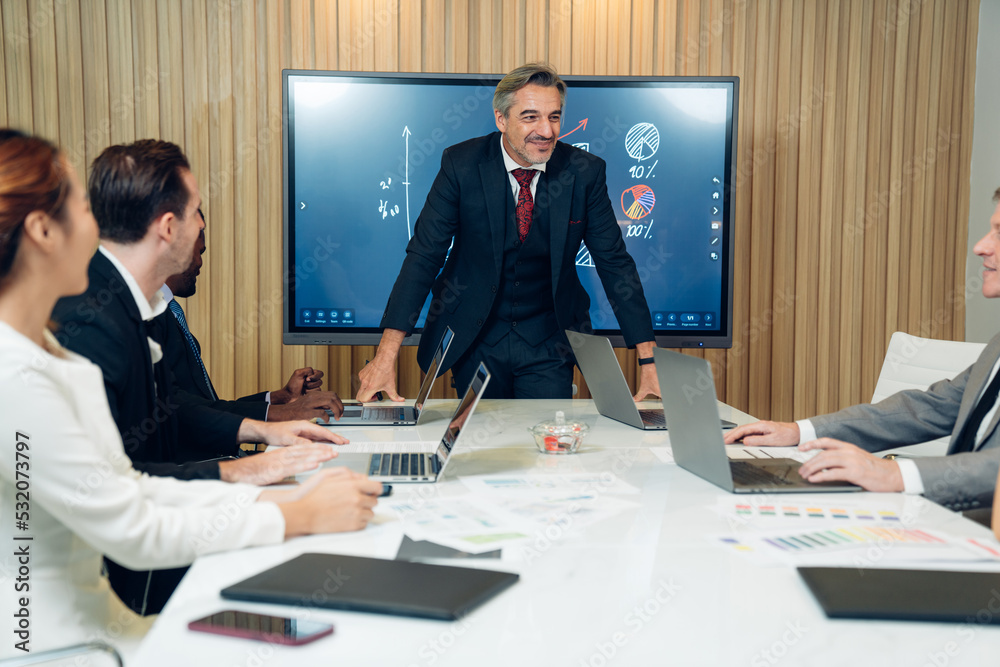 Mature manager leading a discussion in a boardroom, brainstorming discussed about work in conference room in the creative office. Mature manager leading a discussion in a boardroom, brainstorming discussed about work in conference room in the creative office.