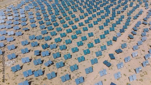 Aerial view of the largest thermal power plant in the world. A glittering sea of mirrors concentrate sunlight into the clean energy across the solar plant. High quality 4k footage photo