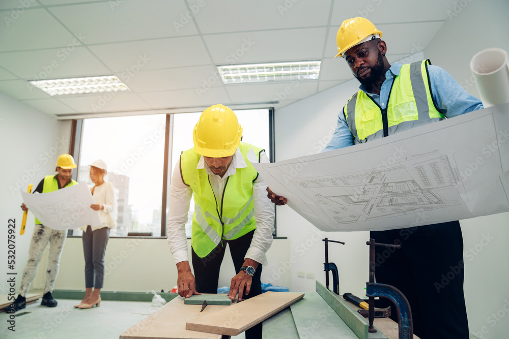 Architector and engineers with draft plan of building and laptop talking on constructing site. Construction manager and engineer working on building site in the office, teamwork. Architector and engineers with draft plan of building and laptop talking on constructing site. Construction manager and engineer working on building site in the office, teamwork.