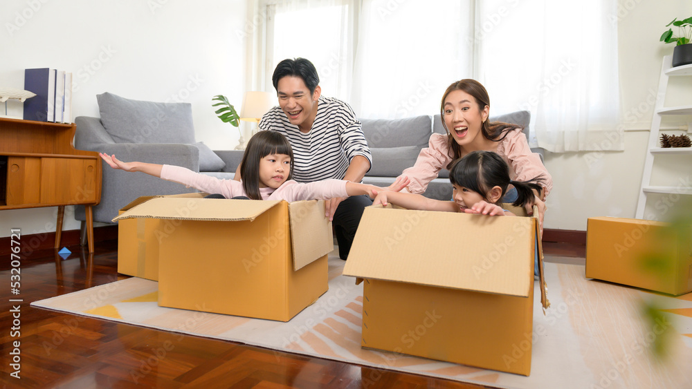Asian family husband and wife and children with cardboard boxes having fun on moving day, Mortgage, loan, property and insurance concept. Asian family husband and wife and children with cardboard boxes having fun on moving day, Mortgage, loan, property and insurance concept.