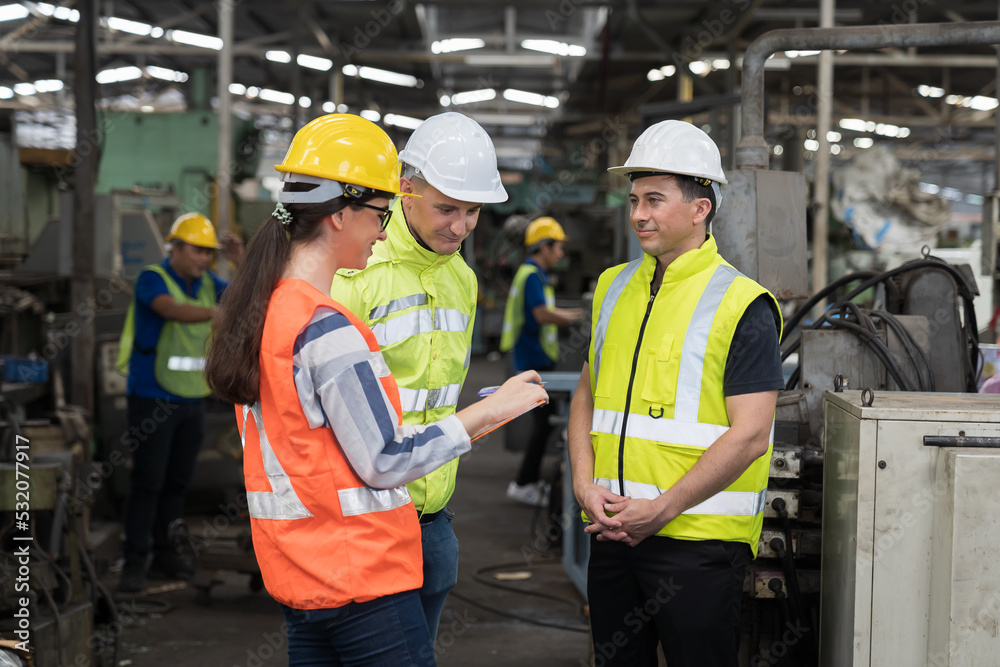 Group of male and female engineer discussing and training about work at the factory. Team of engineer checking and maintaining machines in the factory Group of male and female engineer discussing and training about work at the factory. Team of engineer checking and maintaining machines in the factory