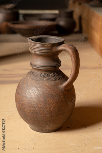 Pottery Craft. a ceramic product with your own hands, made on a Potter's wheel isolated on a white background. © nikolay_alekhin