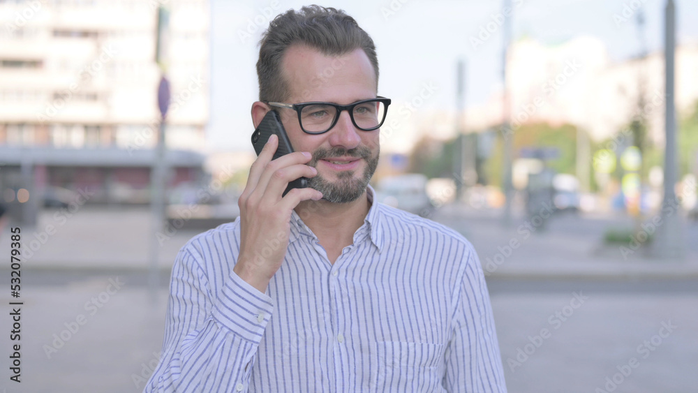 Young Adult Man Talking on Phone while Standing Outdoor Young Adult Man Talking on Phone while Standing Outdoor