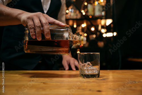 Barman pouring whiskey whiskey glass beautiful night