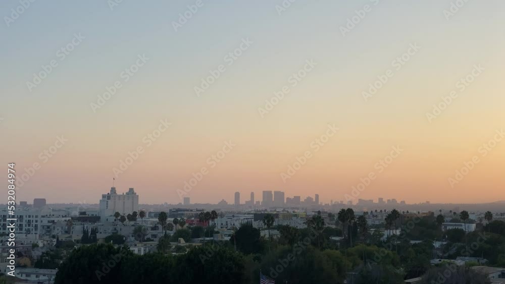 Evening View of Downtown Los Angeles In The Distance As The Sun Is Setting With Palm Trees, California, USA Evening View of Downtown Los Angeles In The Distance As The Sun Is Setting With Palm Trees, California, USA