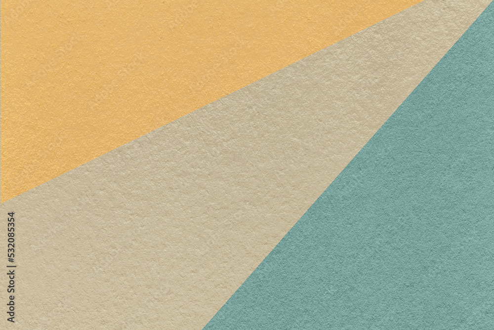 Texture of old craft beige, blue and yellow color paper background, macro. Vintage abstract cerulean cardboard.