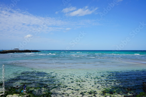 clear shoaling beach and seaside gazebo