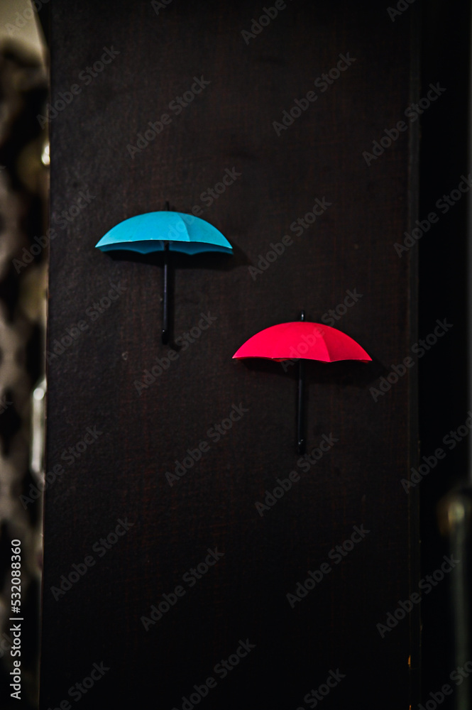 rain and umbrella. Small red blue umbrella for rain. Blue and Red Umbrella on wooden background