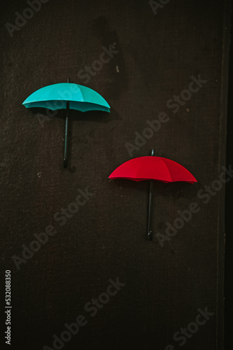 Lovely Small red and blue umbrella. Blue and Red Umbrella on wooden background.
