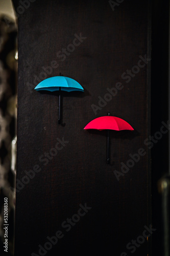 rain and umbrella. Small red blue umbrella for rain. Blue and Red Umbrella on wooden background