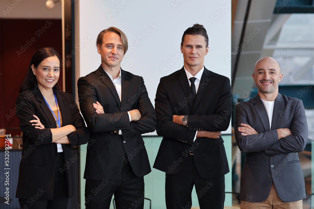 Portrait of multiethnic businessman and businesswoman in formal suit standing and arms cross with confident while looking camera with happy face in modern office. Success business concept Portrait of multiethnic businessman and businesswoman in formal suit standing and arms cross with confident while looking camera with happy face in modern office. Success business concept