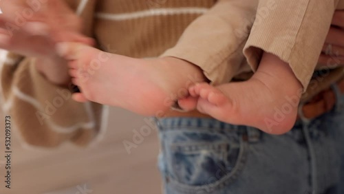 Mom, dad and baby, playing with toes at home and closeup. Love, family and parenting, mother standing, having fun with child and father. Man, woman and happy child development through care and play. photo