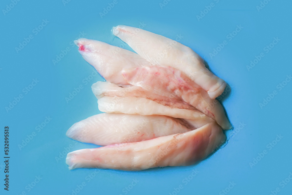 Monk fish fillets on blue ocean color surface. Seafood product with fine taste and soft tender feel. Fish monger craft. Monk fish fillets on blue ocean color surface. Seafood product with fine taste and soft tender feel. Fish monger craft.