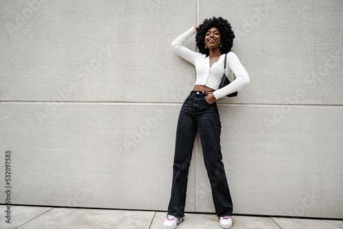 Fotótapéta Black woman posing in front of a gray concrete wall