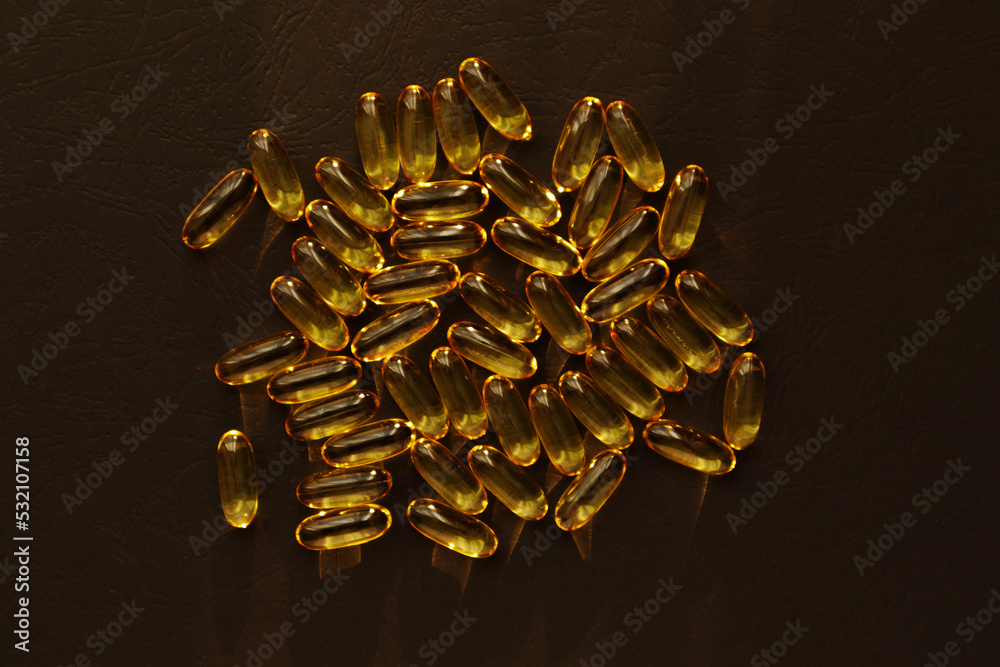 Fish oil pills. Omega 3 gel capsules on black background