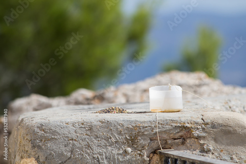 Alpiste y agua que dejan los senderistas a las pequeñas aves en el mirador de la cruz del preventorio, Alcoy photo