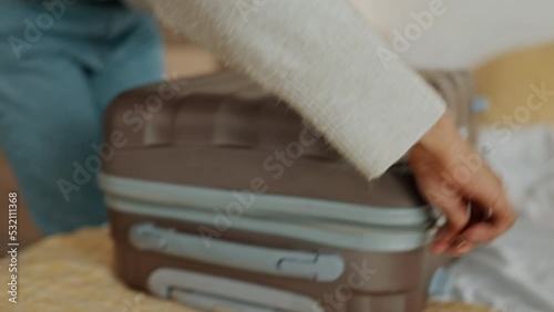 Hands of black woman packing suitcase clothes fast in bedroom at house, home and late for winter road or air travel trip. African girl in hurry with clothing luggage bag in flat apartment for journey