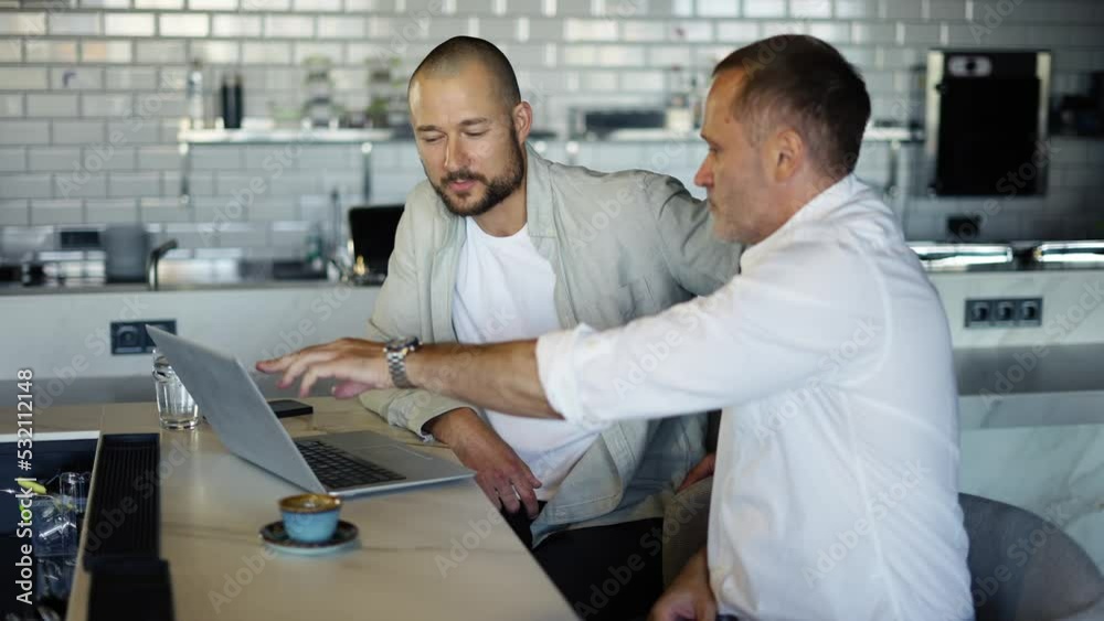 Two motivated businessmen are discussing a project during lunch. Take a break from work. Modern world providence Two motivated businessmen are discussing a project during lunch. Take a break from work. Modern world providence