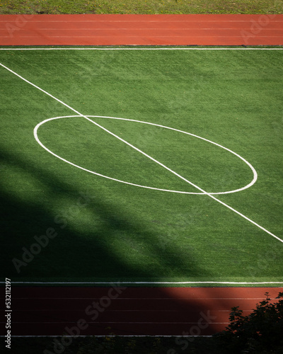 Abstract geometry of a soccer field with a running track. Symbol of sport and healthy lifestyle. Top view of the stadium.