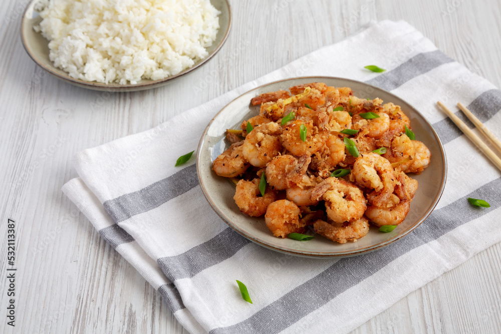 Homemade Crispy Salt and Pepper Shrimp with Scallions on a Plate, low angle view. Homemade Crispy Salt and Pepper Shrimp with Scallions on a Plate, low angle view.