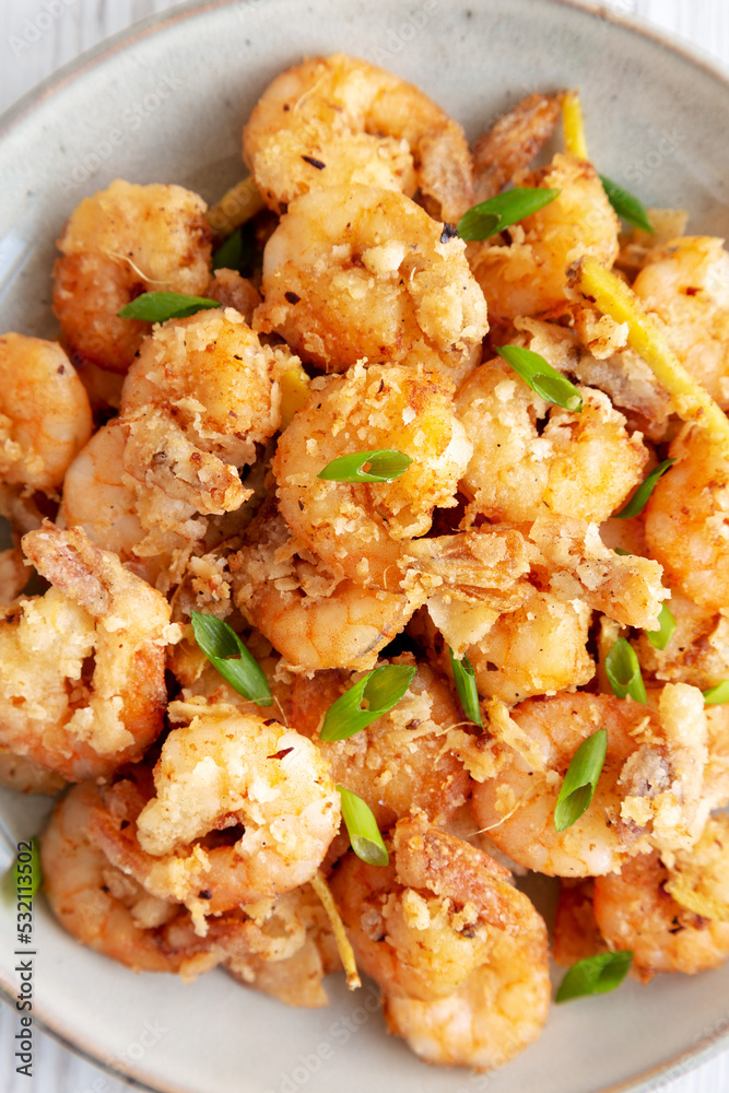 Homemade Crispy Salt and Pepper Shrimp with Scallions on a Plate, top view. Flat lay, overhead, from above. Homemade Crispy Salt and Pepper Shrimp with Scallions on a Plate, top view. Flat lay, overhead, from above.