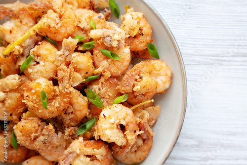 Homemade Crispy Salt and Pepper Shrimp with Scallions on a Plate, top view. Flat lay, overhead, from above. Copy space.