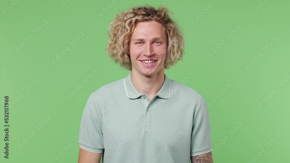 Young cheerful happy fun friendly satisfied optimistic caucasian blond man 20s he wearing blue t-shirt isolated on plain pastel light green color background studio portrait. People lifestyle concept Young cheerful happy fun friendly satisfied optimistic caucasian blond man 20s he wearing blue t-shirt isolated on plain pastel light green color background studio portrait. People lifestyle concept