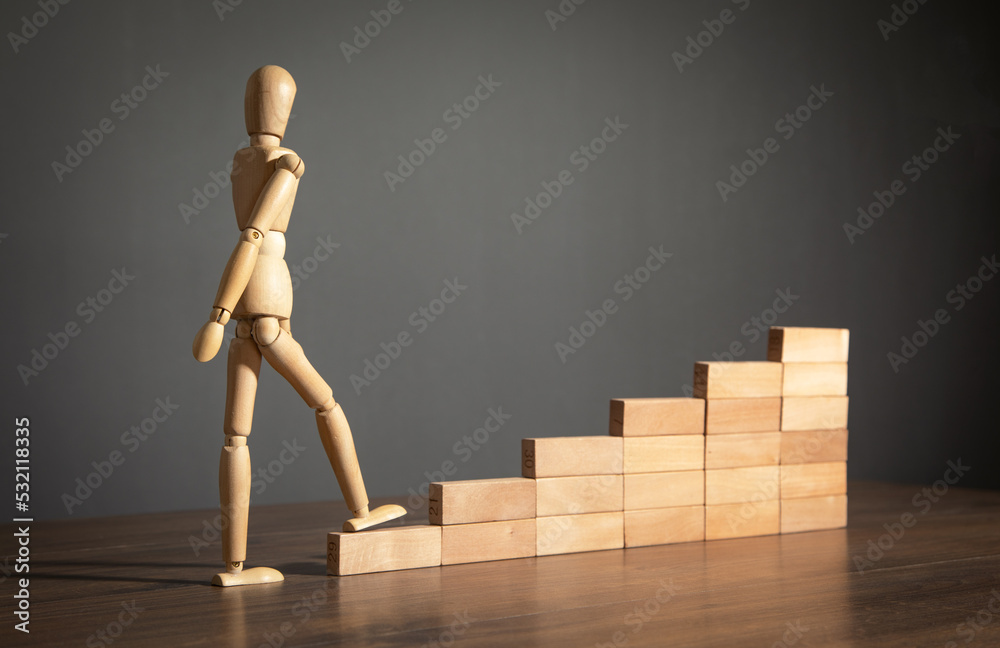 Wooden human figure climbing in stairs. Business. Career Wooden human figure climbing in stairs. Business. Career