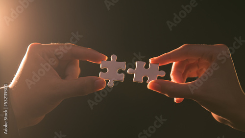 Close-up of business hands connecting jigsaw puzzle, business problem solving, success and goal achievement, the last jigsaw is the link of all the pieces.