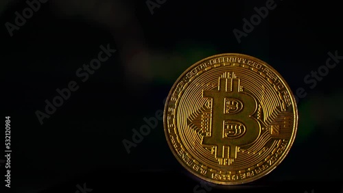 Bitcoin coin on background of a cryptocurrency trading chart on computer screen. Digital money, banking, investment, finance and business concept. photo