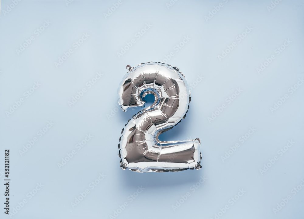 Silber balloon number 2 on light blue background for your New Year of birthday desing Silber balloon number 2 on light blue background for your New Year of birthday desing