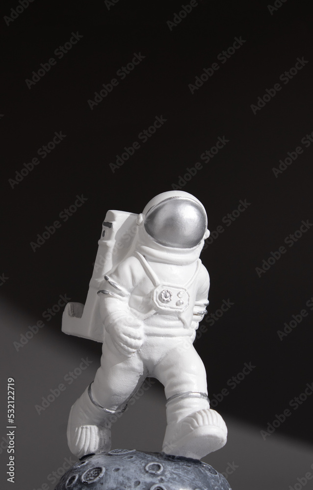 Plastic toy figure astronaut on a dark background. World Space Week 2022. Space and Sustainability. Close-up. Plastic toy figure astronaut on a dark background. World Space Week 2022. Space and Sustainability. Close-up.