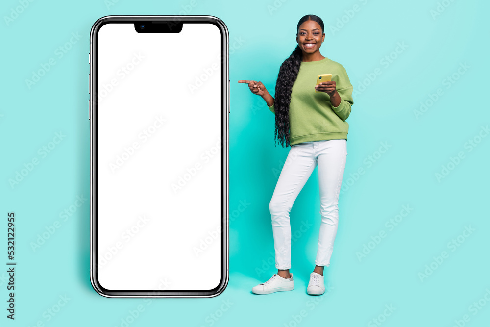 Photo of sweet funny lady wear green sweater arms chatting modern gadget empty space isolated turquoise color background Photo of sweet funny lady wear green sweater arms chatting modern gadget empty space isolated turquoise color background