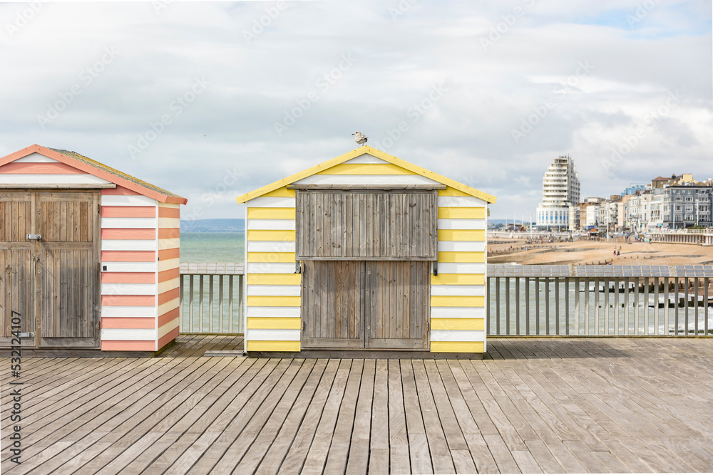colourful pier huts on hasting's pier, copy space