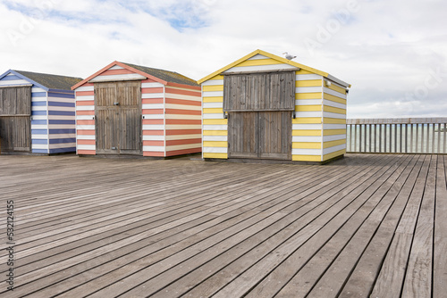 colourfull pier huts on hastings pier, copy space photo