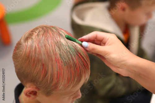 blue hair chalk in human hand dye hair closeup photo