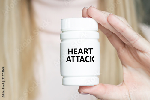 Heart Attack inscription on a white jar in the hands of a doctor, a medical concept