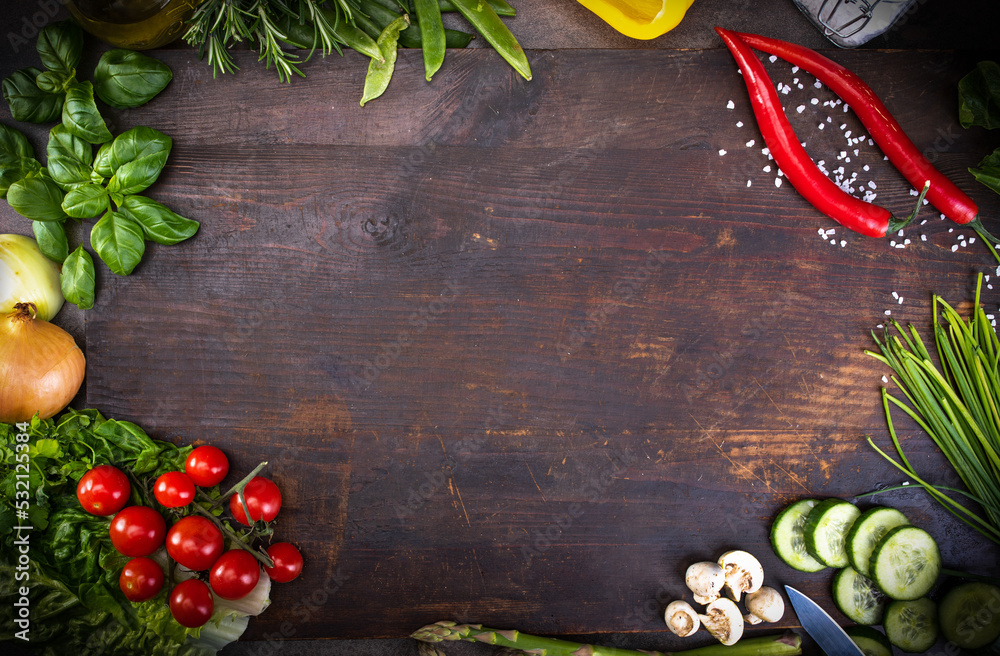 Fresh raw vegetable, herbs, on a rustic wood board. Healthy cooking composition, food frame, background with copy space.