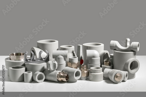 Fotografia Many PVC pipe fittings on the table.
