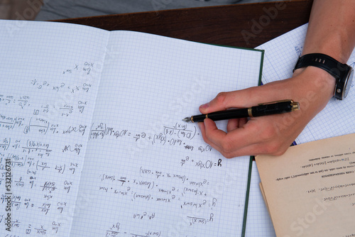 Canvas Print Top view of a student preparing for his math exam