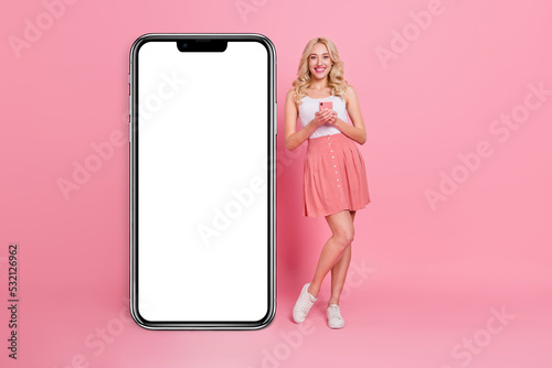 Full length body size view of charming trendy cheery girl using gadget copy space ad eshop isolated over pink pastel color background