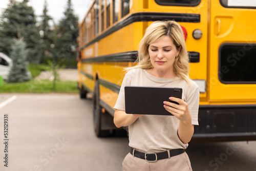 Portrait of positive middle aged woman teacher, psychologist, mentor, therapist, counselor near the school bus